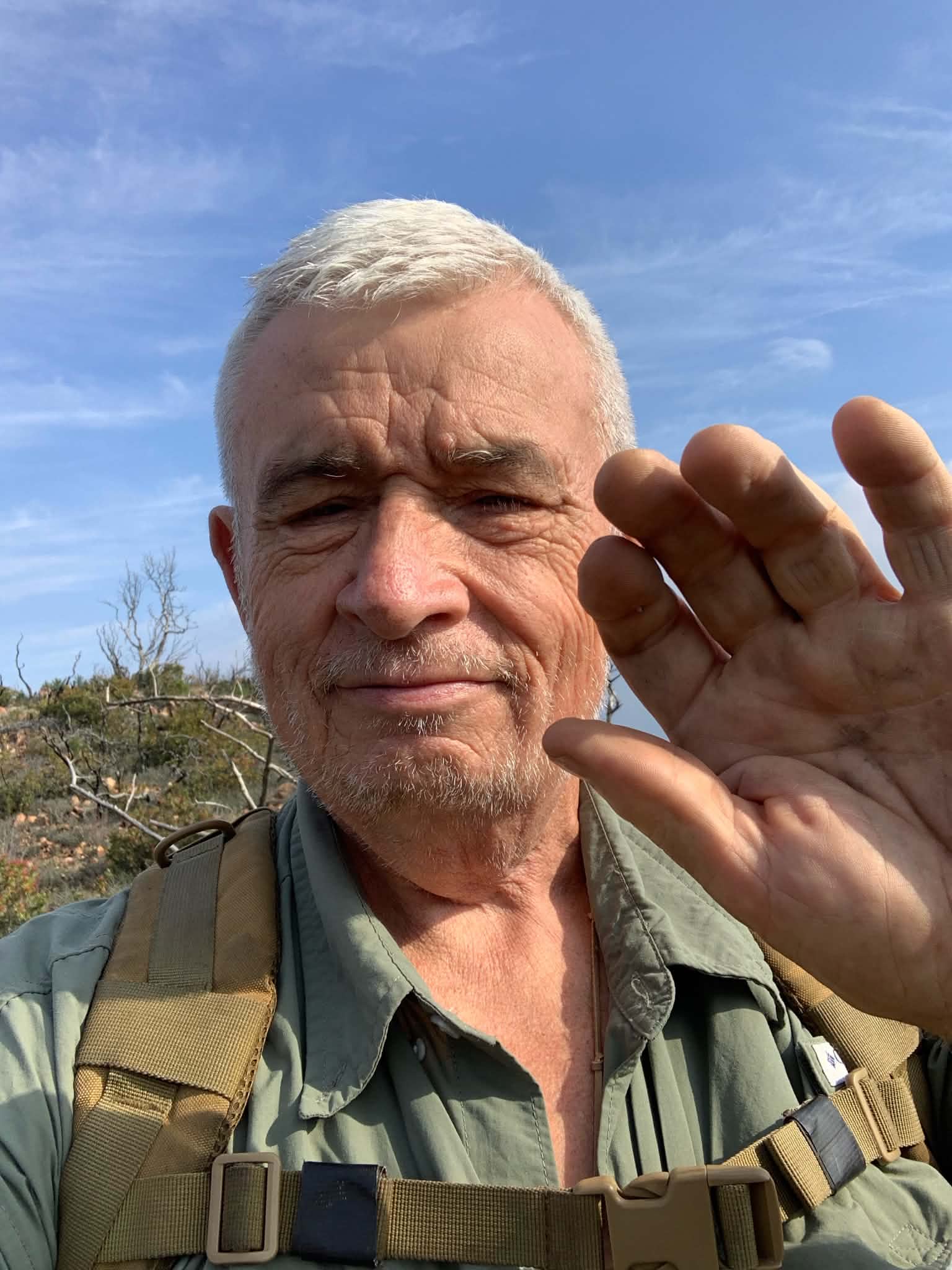 Raymond G. Mills with detector and gold finds